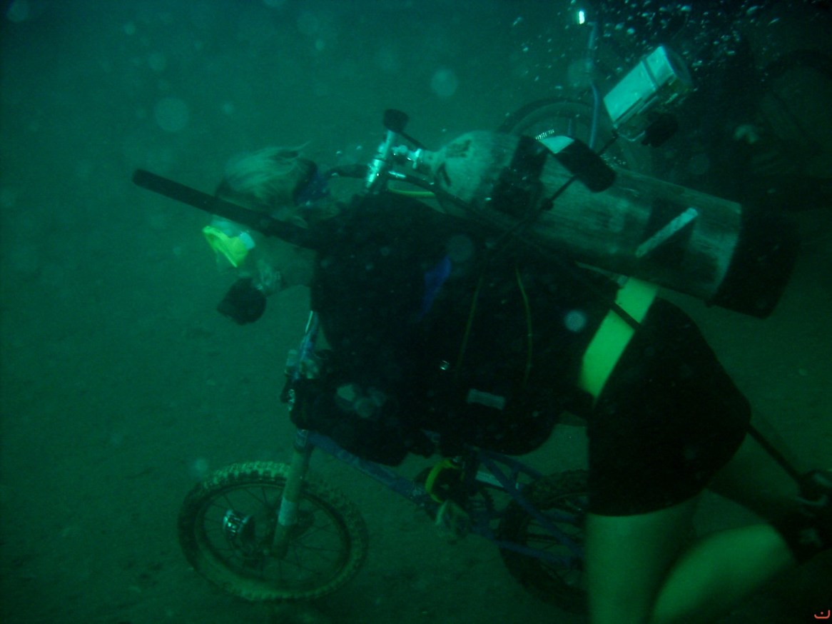 Racing a child-sized bike next to the USS Indra wreck. Photo courtesy of Discovery Diving.