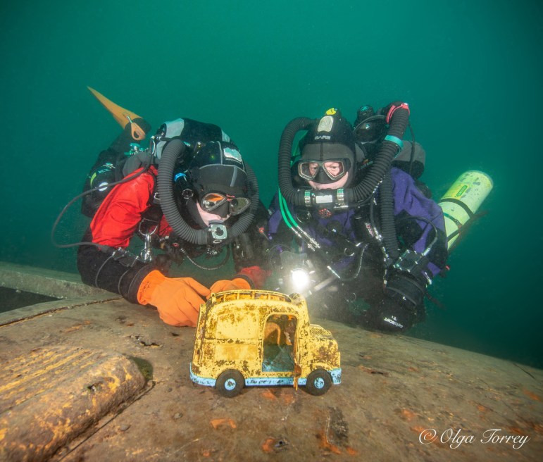 Serious tech divers investigating a child’s toy “wreck” makes this wonderful, silly photo more memorable than just a standard shot. Photo courtesy of Olga Torrey of Fit Image.
