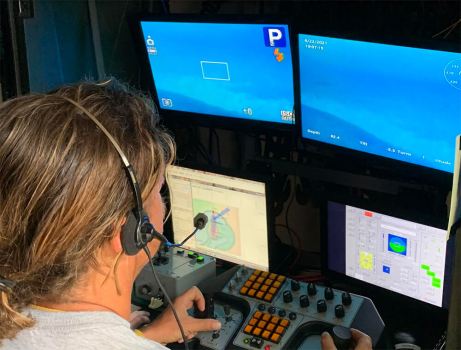 An ROV pilot gets a closer look at a shipwreck while sitting inside of the control room of a U.S. Coast Guard vessel and piloting ROV Mohawk. Image: Ocean Exploration Trust