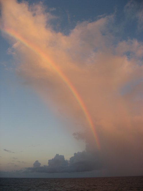 A rainbow stretches over the water in Papahānaumokuākea Marine National Monument. Photo: Paulo Maurin/NOAA